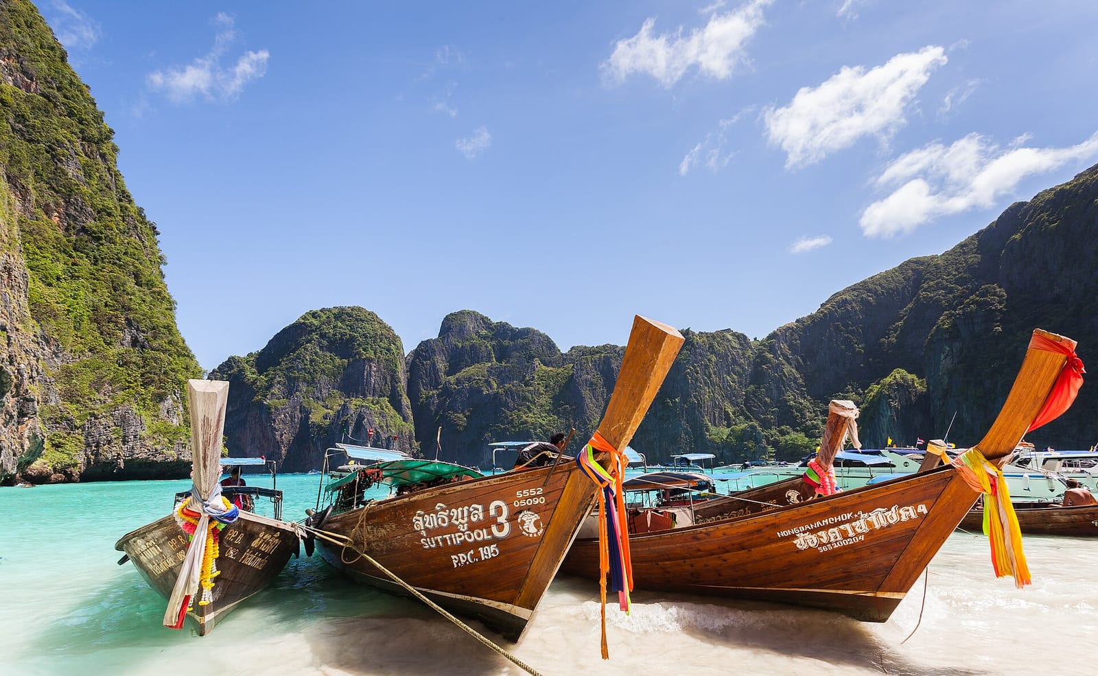 Maya Bay on Phi Phi Leh in 2013, with longtail boats on the sand under the cliffs
