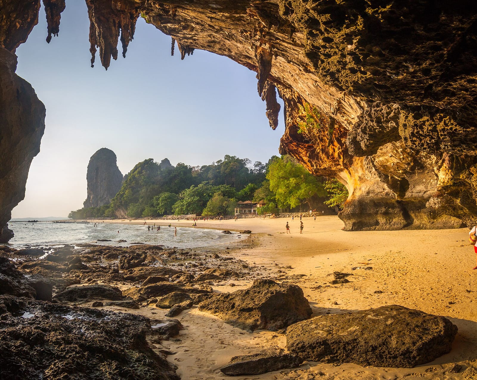 Phra Nang Cave Beach in Krabi, a cliff shrine above pale sand and clear turquoise water