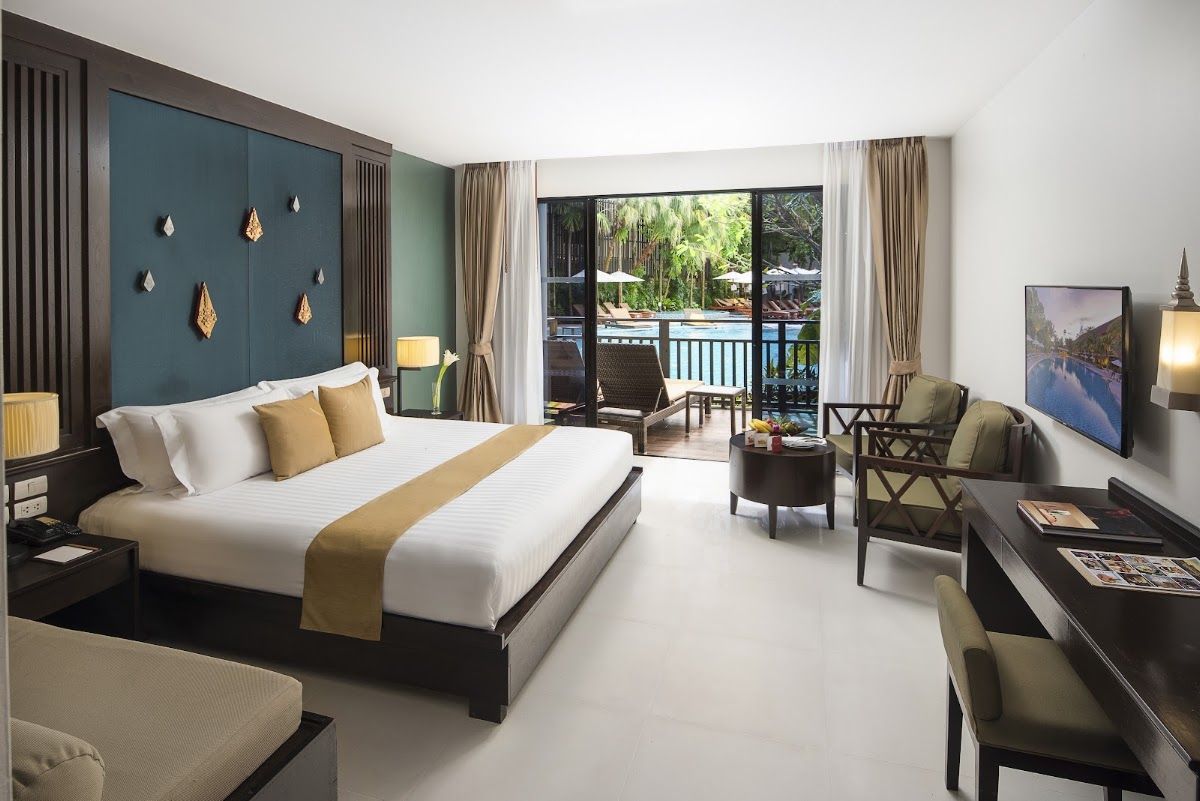 A pool-access room at Centara Anda Dhevi Resort & Spa Krabi, balcony overlooking the pool deck and tropical garden A pool-access room at Centara Anda Dhevi Resort & Spa Krabi, balcony overlooking the pool deck and tropical garden