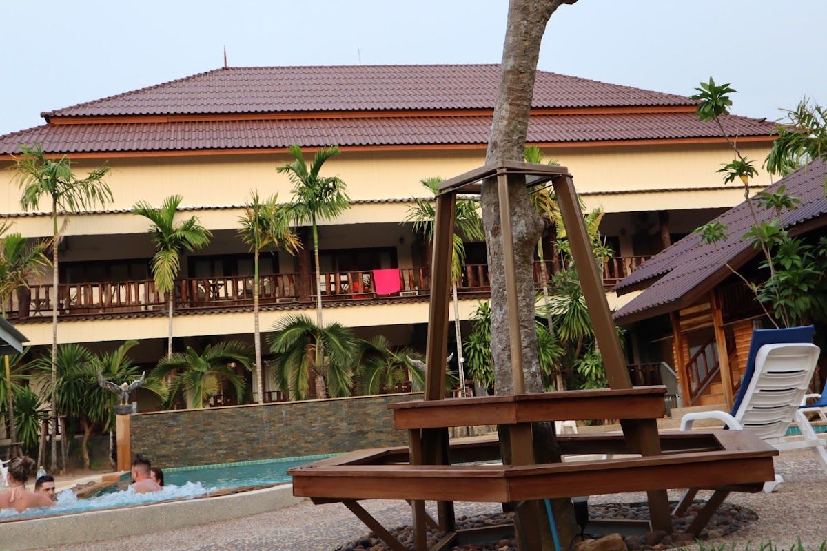 Klong Muang Beach in Krabi with a resort hotel beachfront, calm water and limestone karsts visible offshore Klong Muang Beach in Krabi with a resort hotel beachfront, calm water and limestone karsts visible offshore