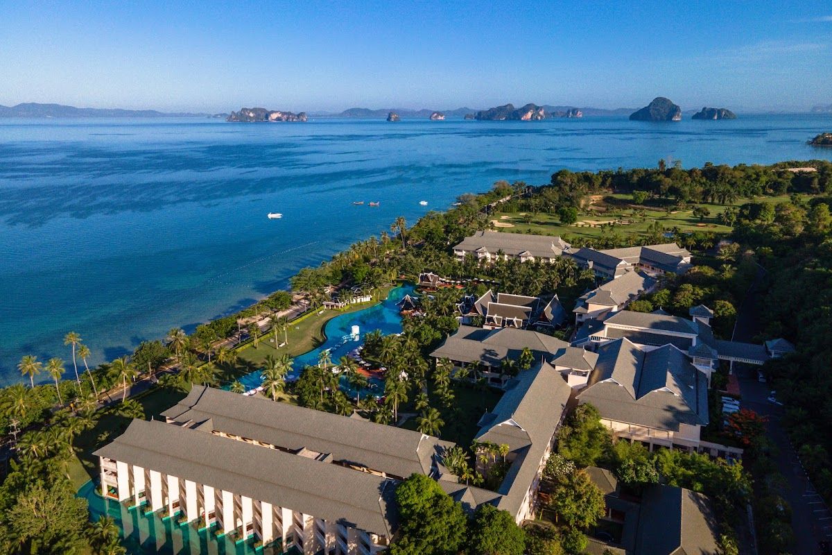 Aerial view of Sofitel Krabi Phokeethra Resort showing the large lagoon pool and beachfront with limestone karst islands in the distance