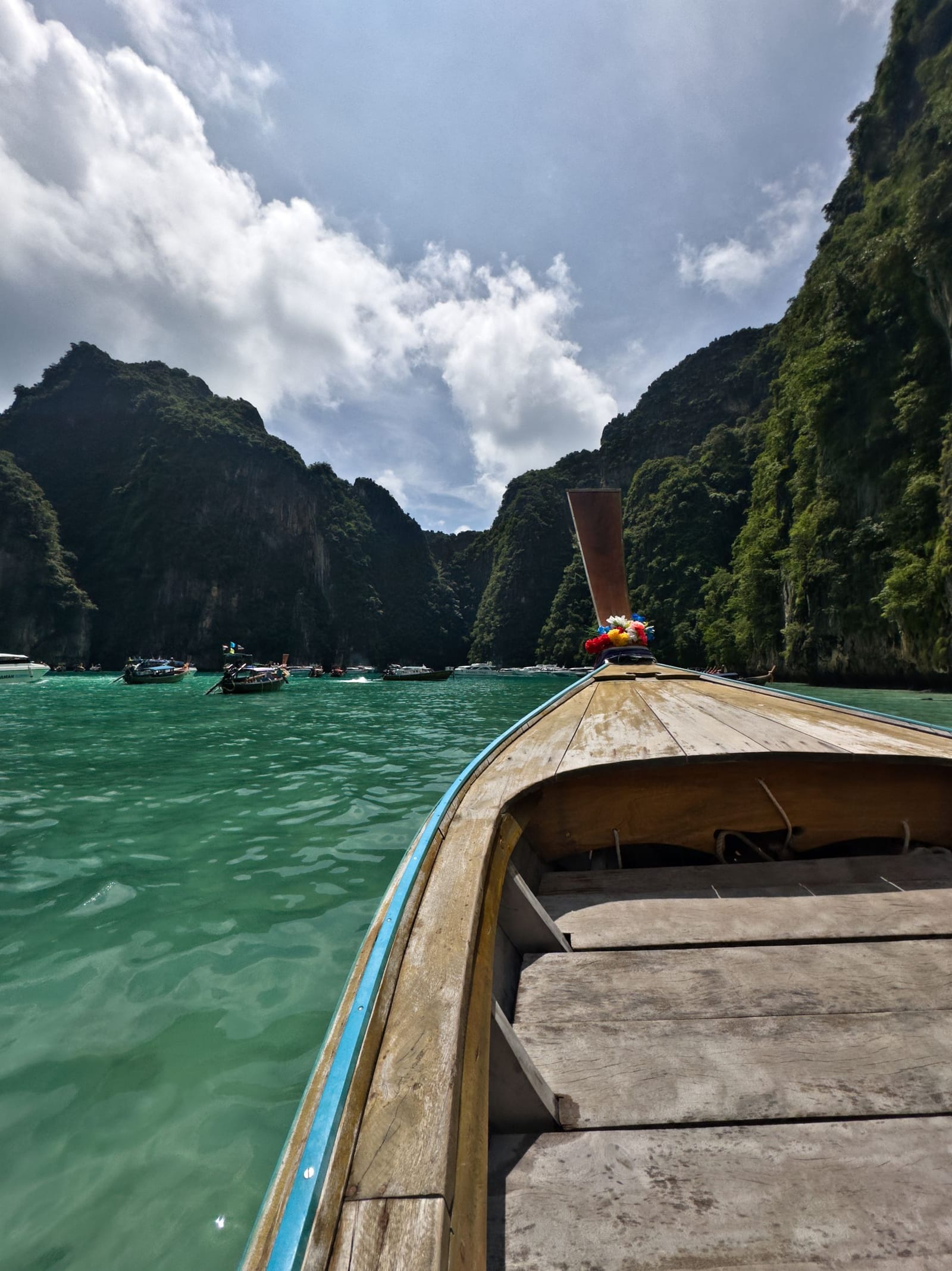 A longtail boat against the limestone cliffs of the Phi Phi islands